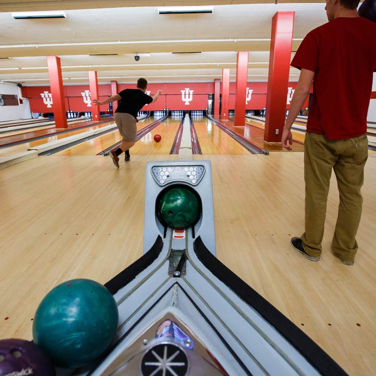 Two students bowl at Bowling and Billiards in the Indiana Memorial Union.