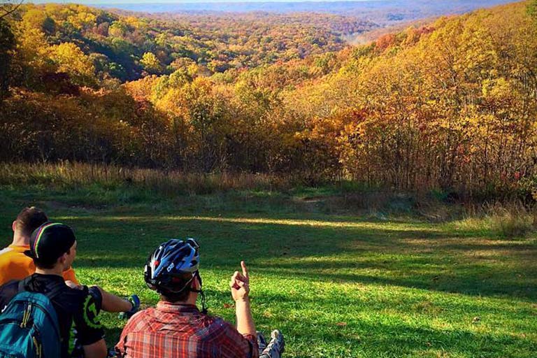 Cyclists pause at a scenic overlook.
