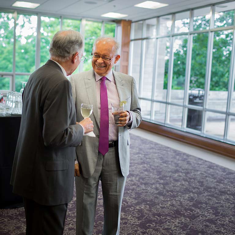 Two guests chat at an event in the Solarium in the Indiana Memorial Union.