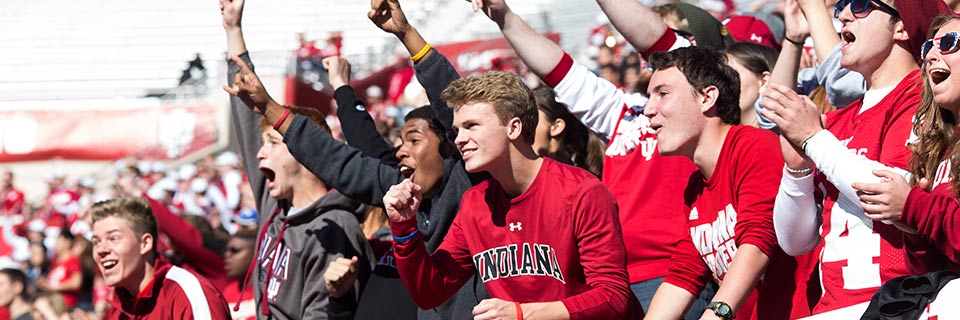 Students cheer at an Indiana University football game at Memorial Stadium.